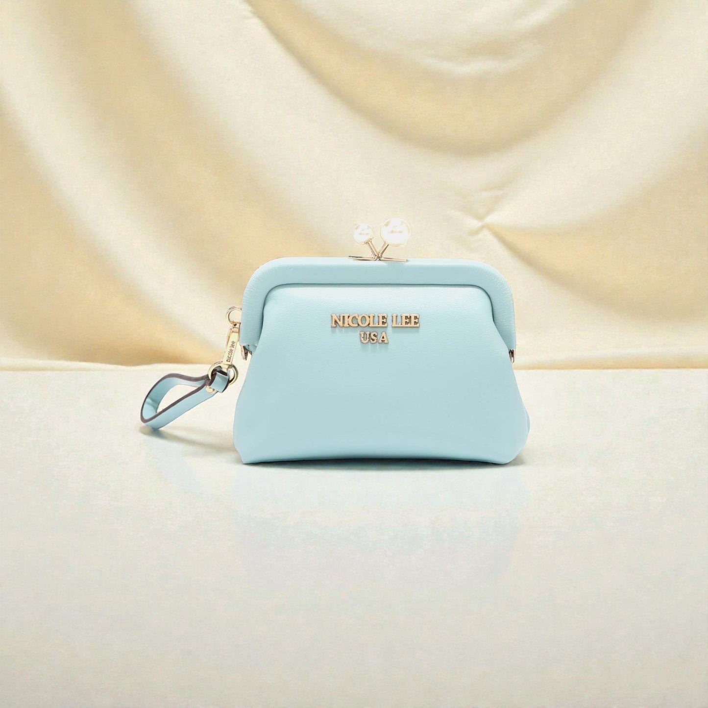 Light blue pouch with 'Nikole Lee' branding on a beige background
