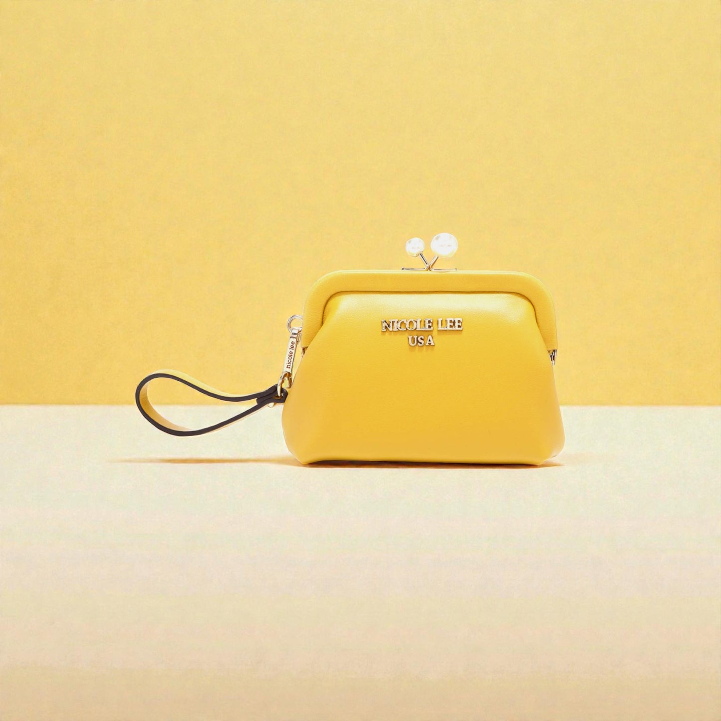 Yellow handbag with 'Nicole Lee' branding on a yellow background