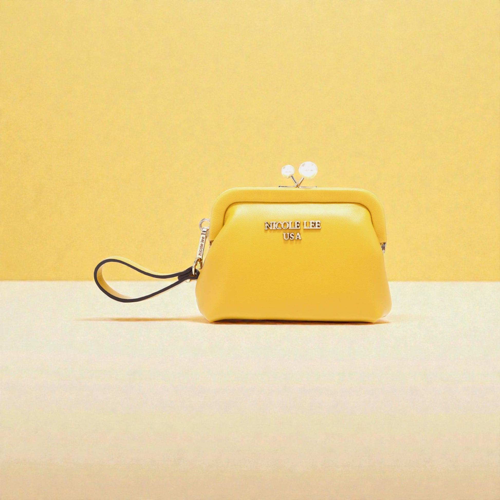 Yellow handbag with 'Nicole Lee' branding on a yellow background