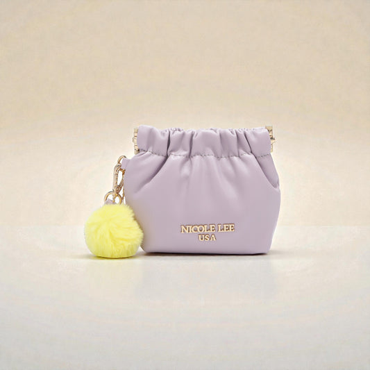 Small purple pouch with a yellow pom-pom keychain on a light beige background