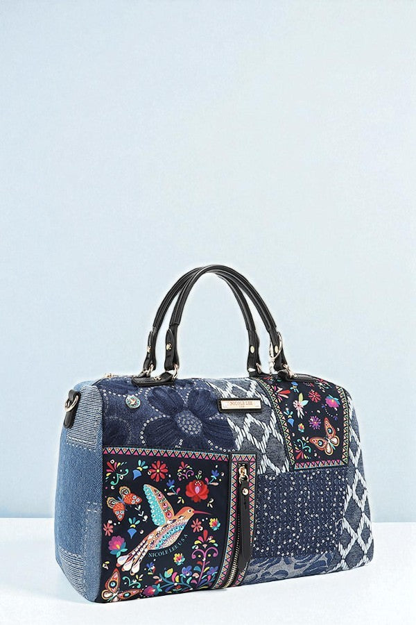 Denim handbag with floral and bird patterns on a light blue background