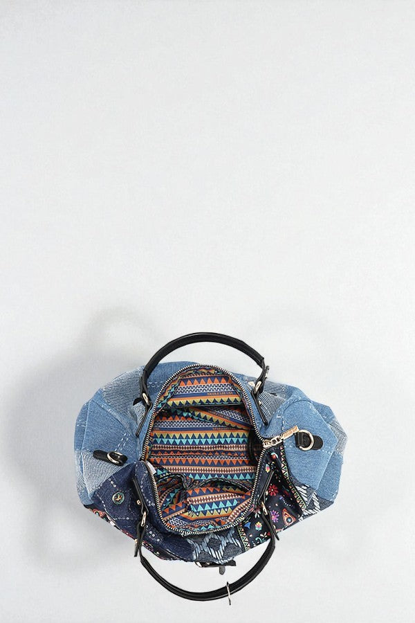 Denim backpack with patterned front pocket on a white background