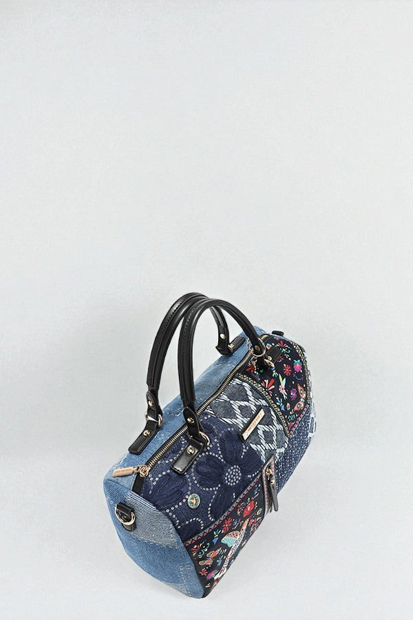 Blue denim handbag with floral patterns on a white background