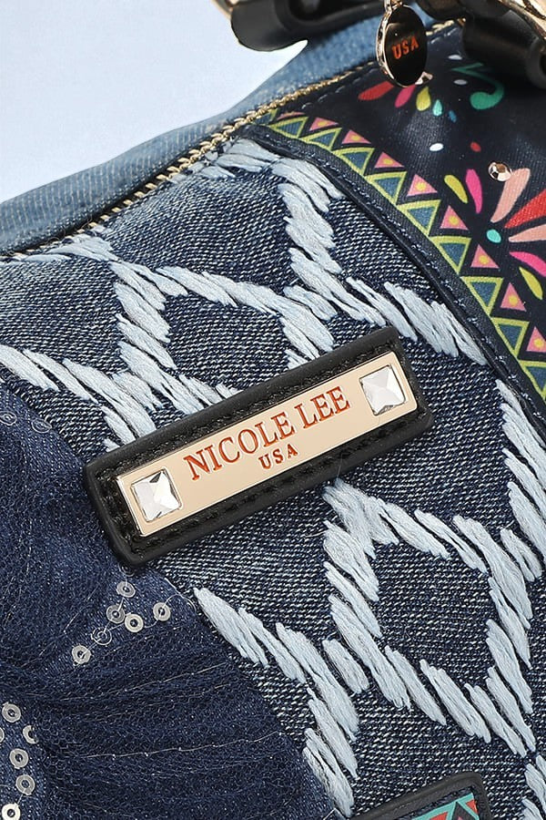 Close-up of a Nicole Lee bag with a colorful patterned strap.
