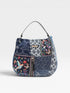 Multicolored handbag with floral and geometric patterns on a white background