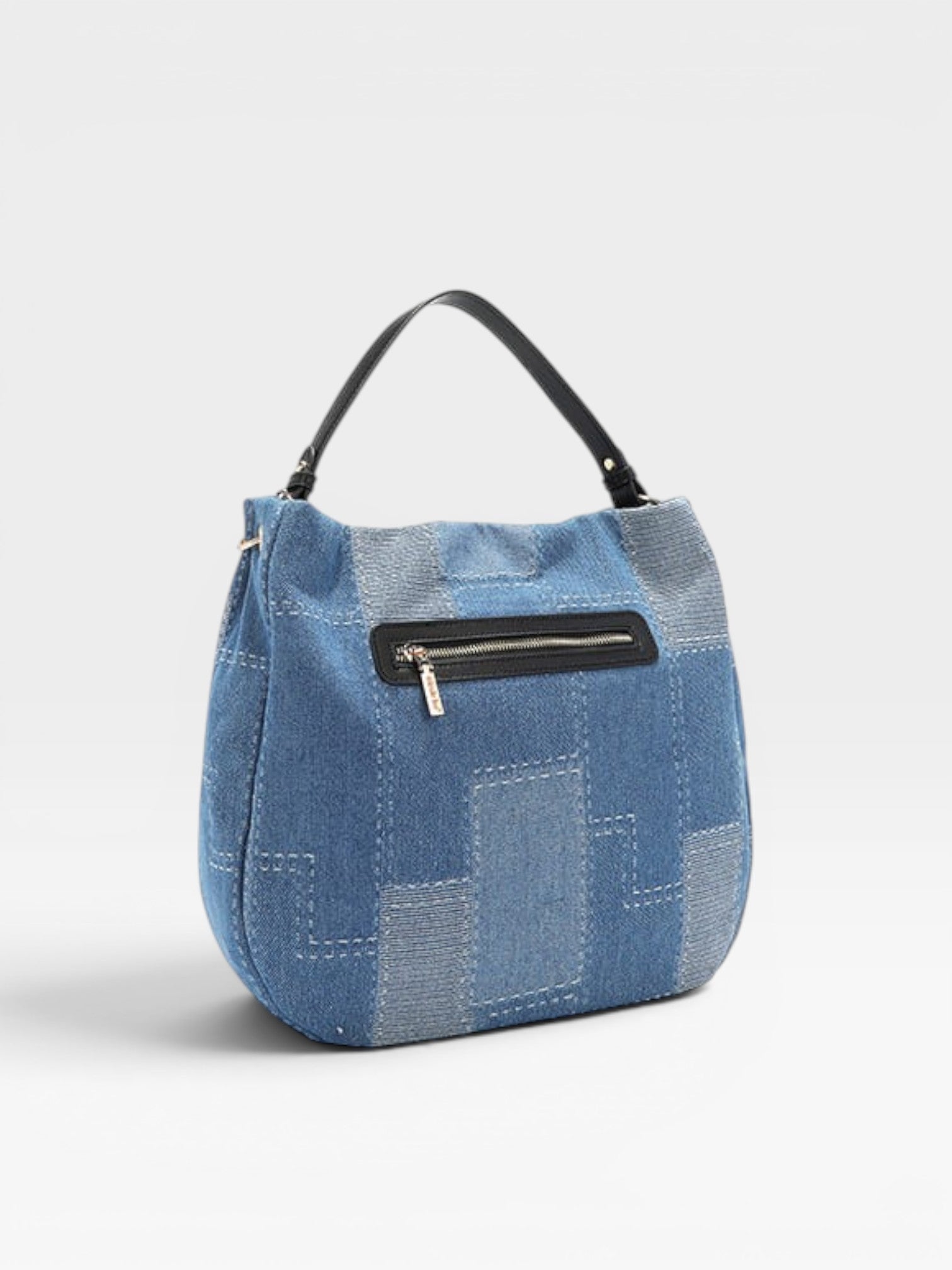 Blue patchwork handbag with a black zipper on a white background