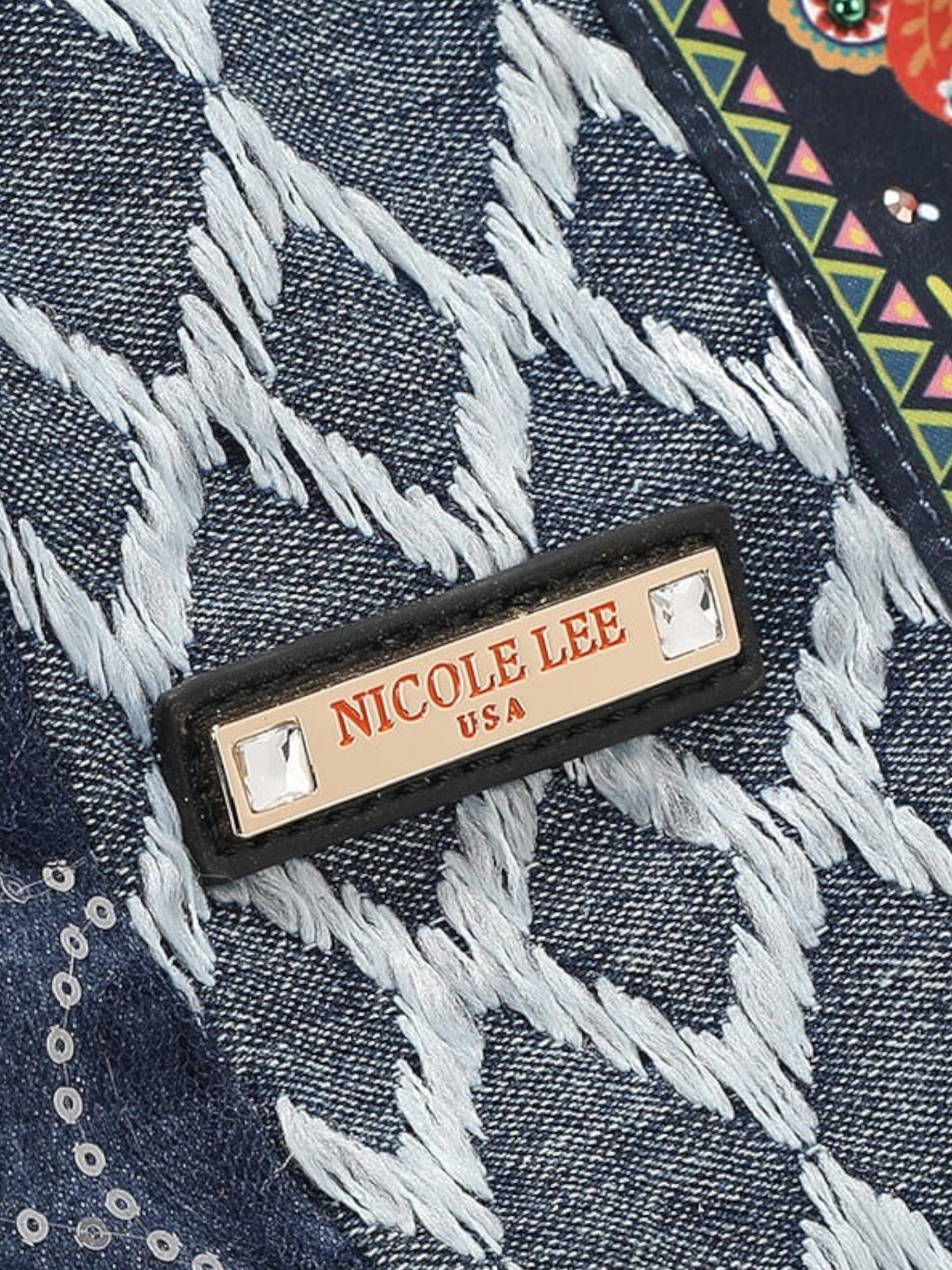 Nicole Lee label on a denim fabric background