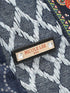 Nicole Lee label on a denim fabric background