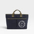 Navy tote bag with green handles and a smiley face design on a white background