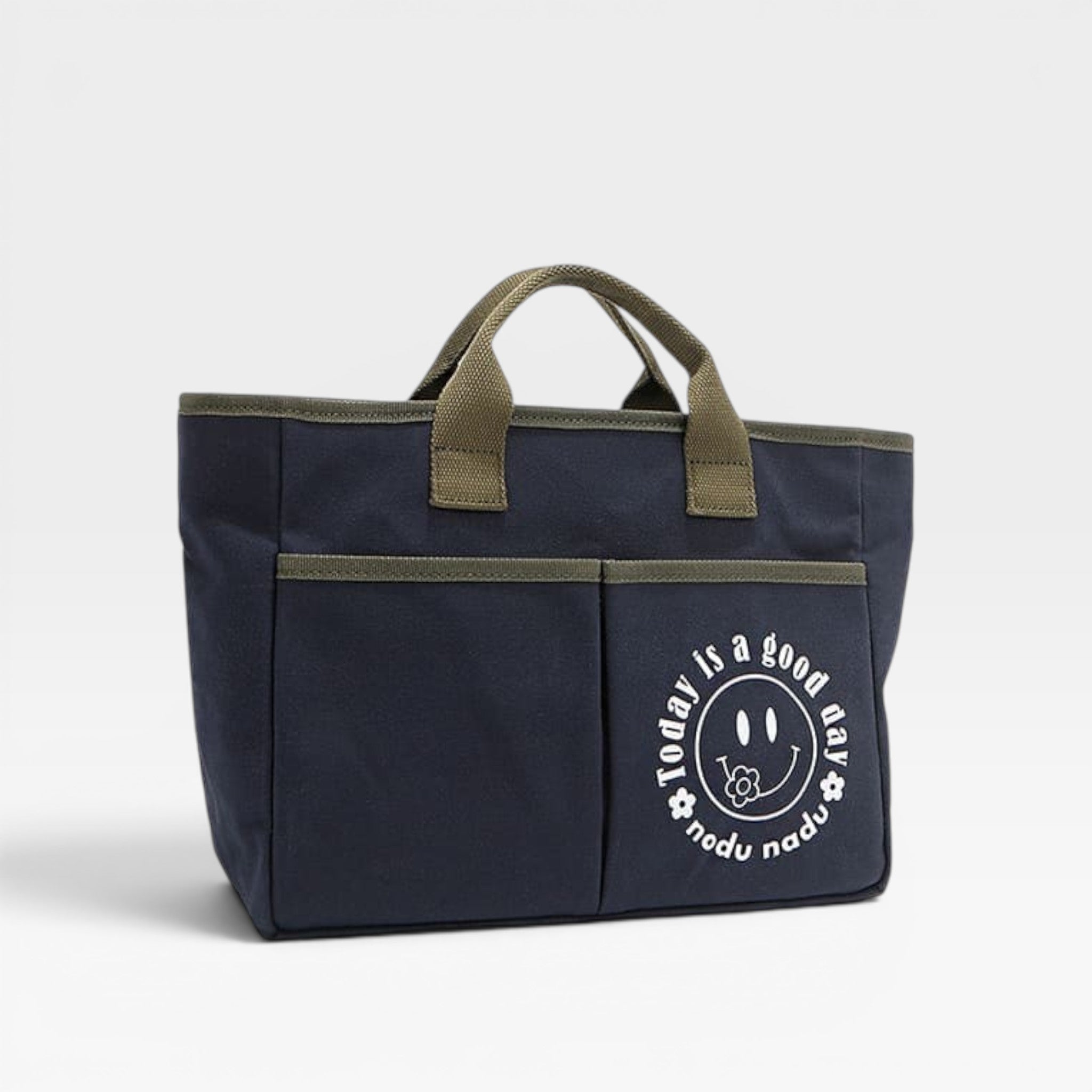 Navy blue bag with green handles and a smiley face design on a white background