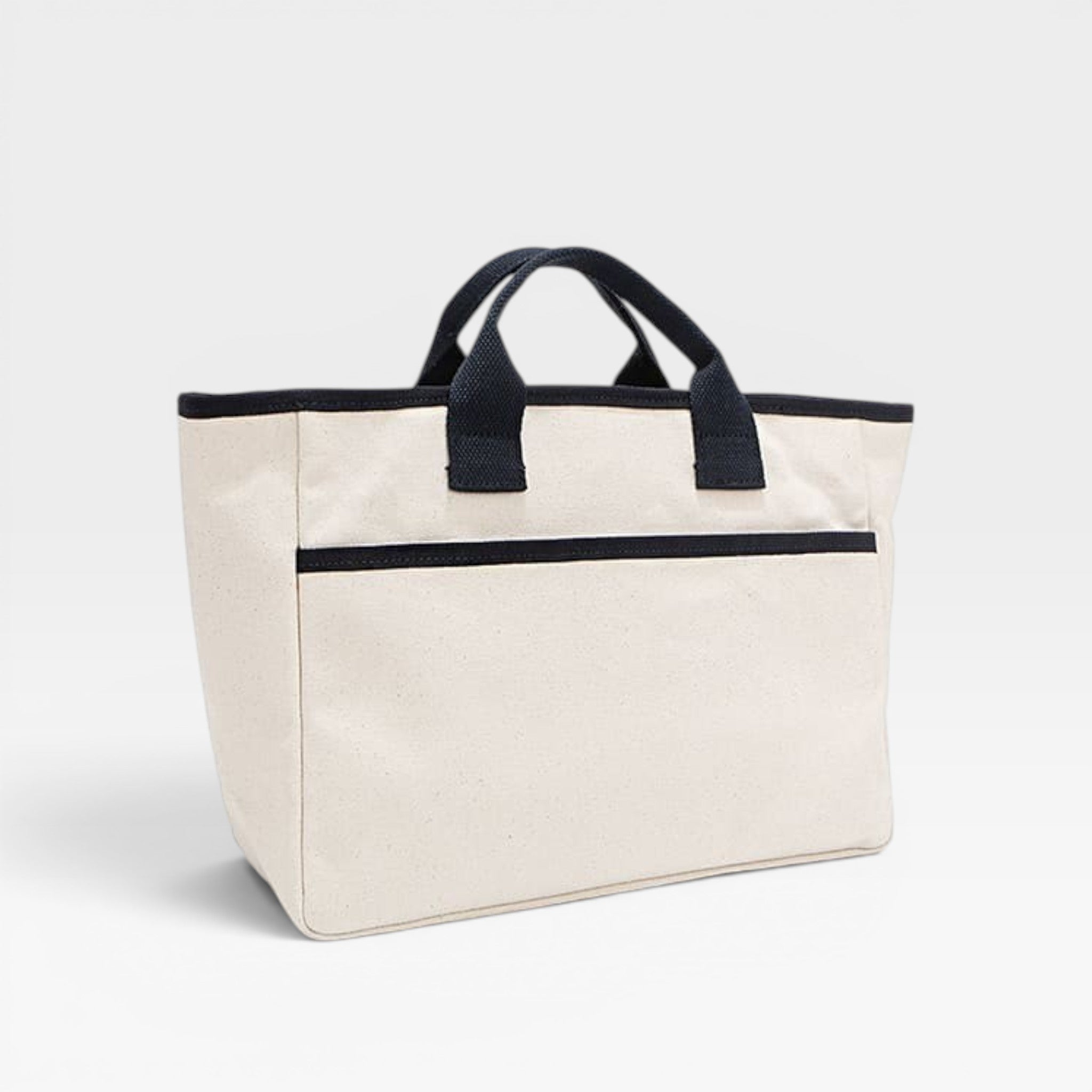 Beige tote bag with black handles and trim on a light gray background