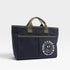 Navy blue bag with green handles and a smiley face design on a white background