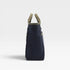 Navy blue bag with beige handles on a light gray background