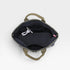 Open backpack with a white strap and pink tag on a light gray background