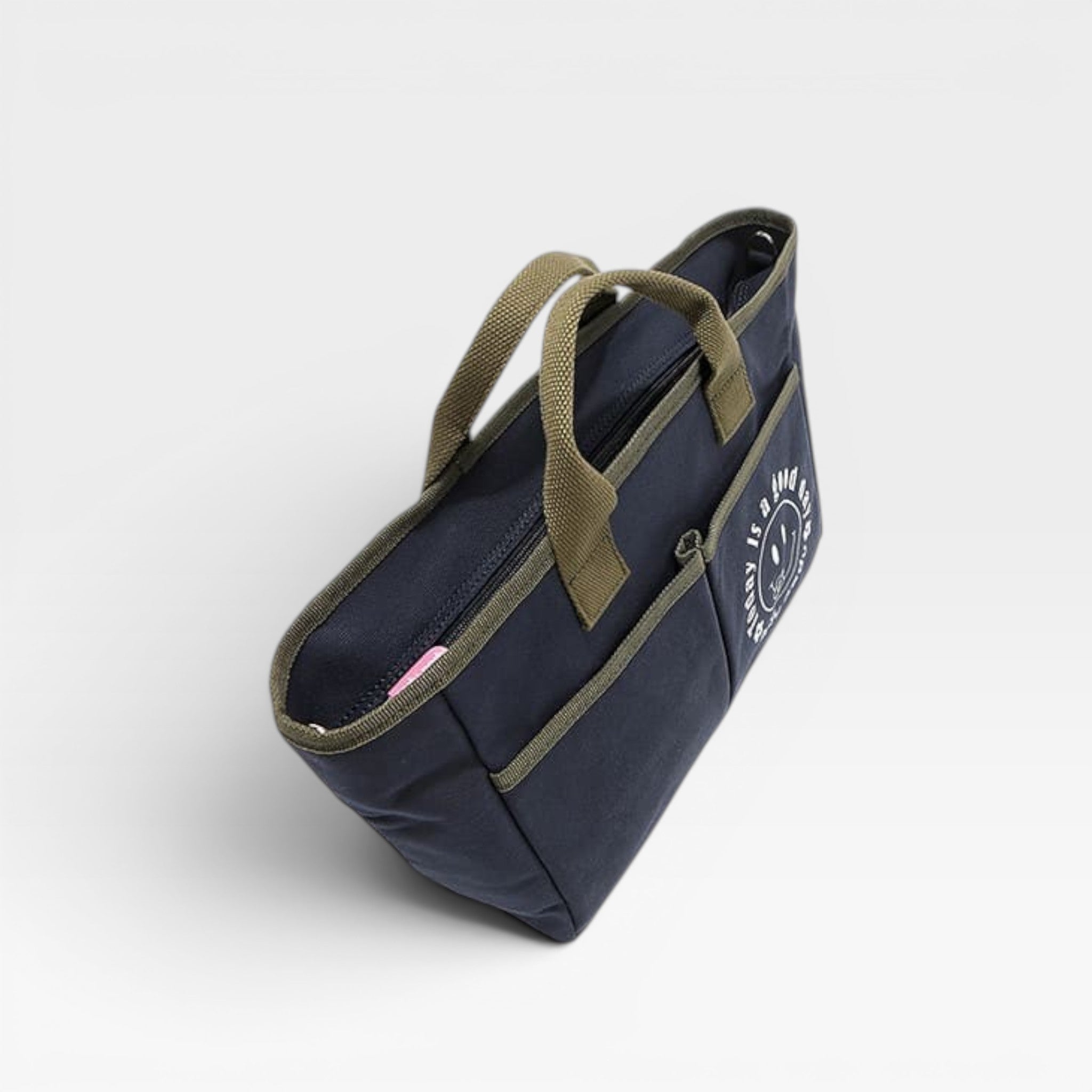 Navy blue bag with green handles on a light gray background