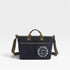 Navy blue bag with green straps and a smiley face logo on a white background