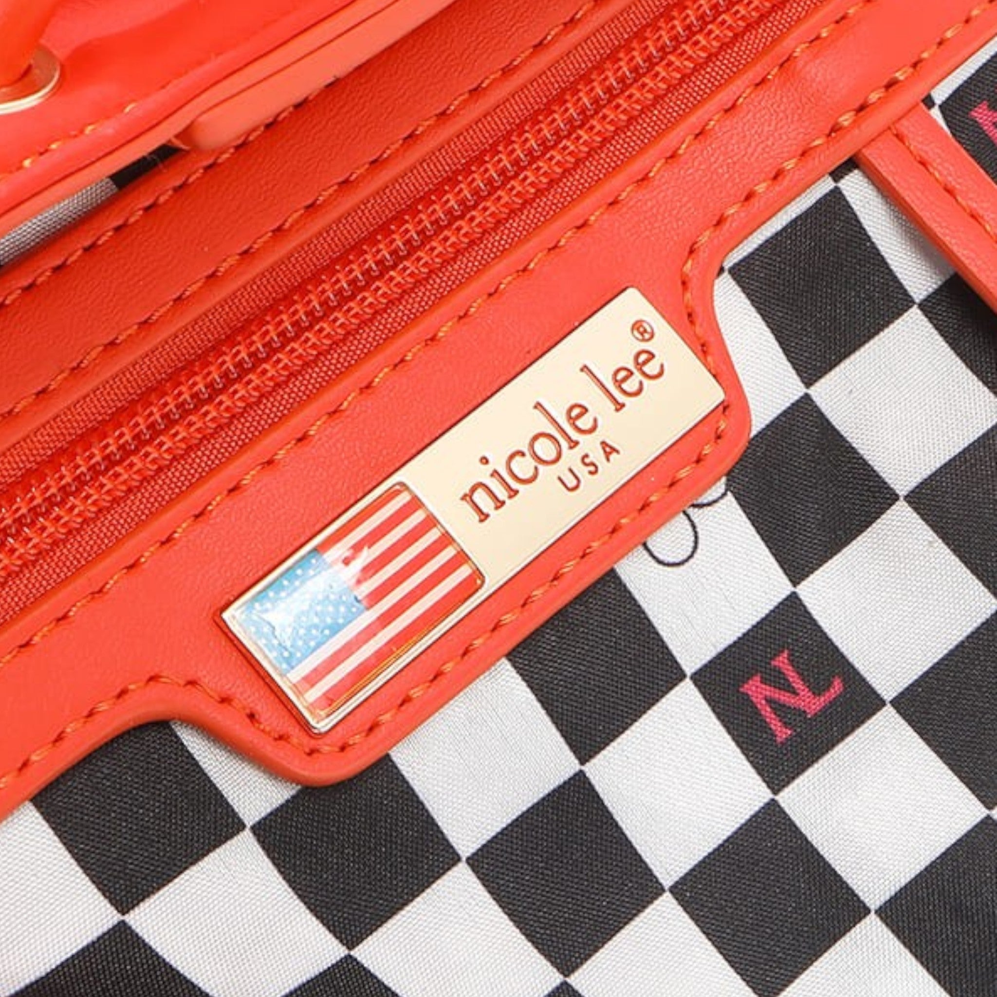 Red wallet with 'nicole lee' brand label on a checkered background