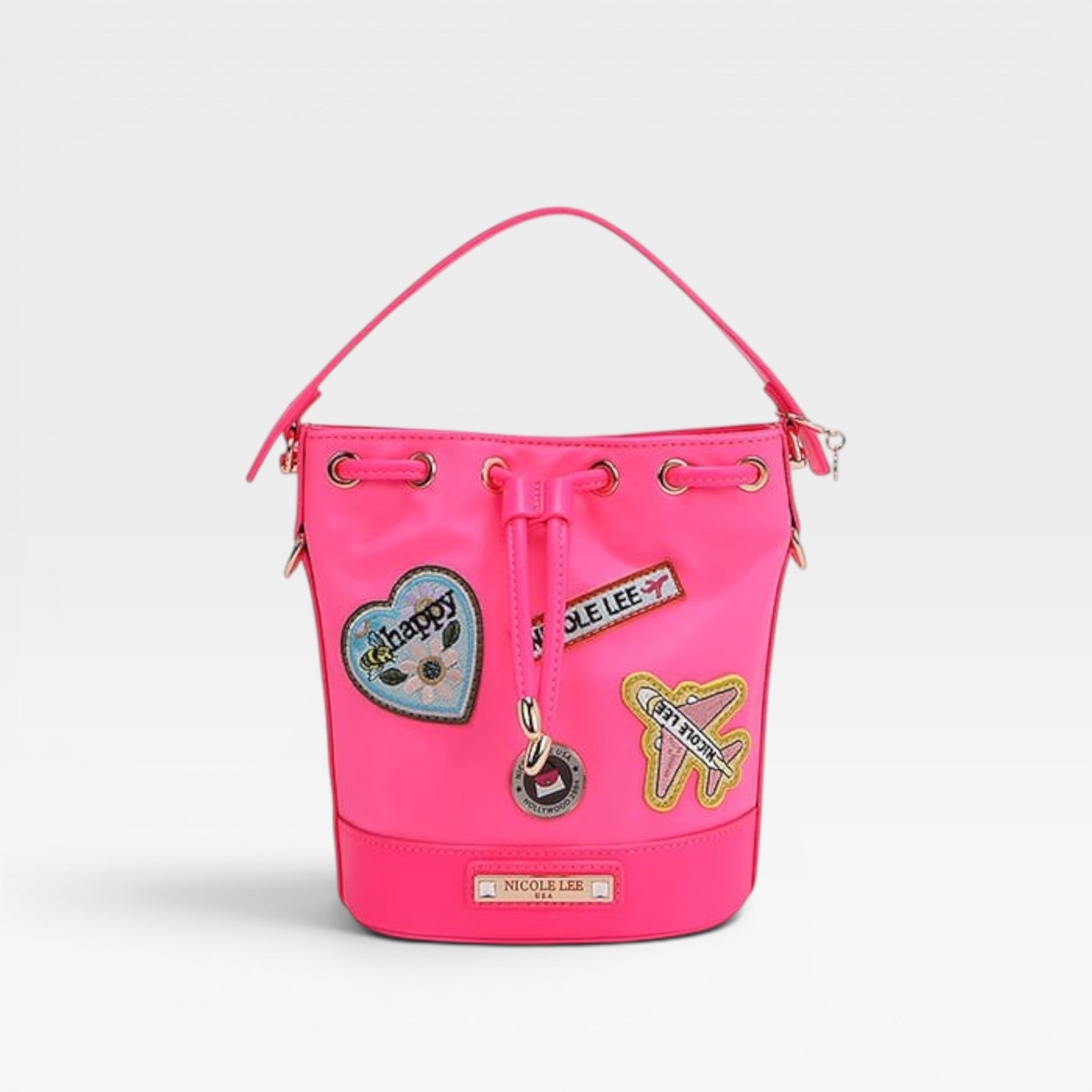 Pink bucket bag with patches on a light gray background