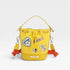 Yellow bucket bag with patches on a light gray background