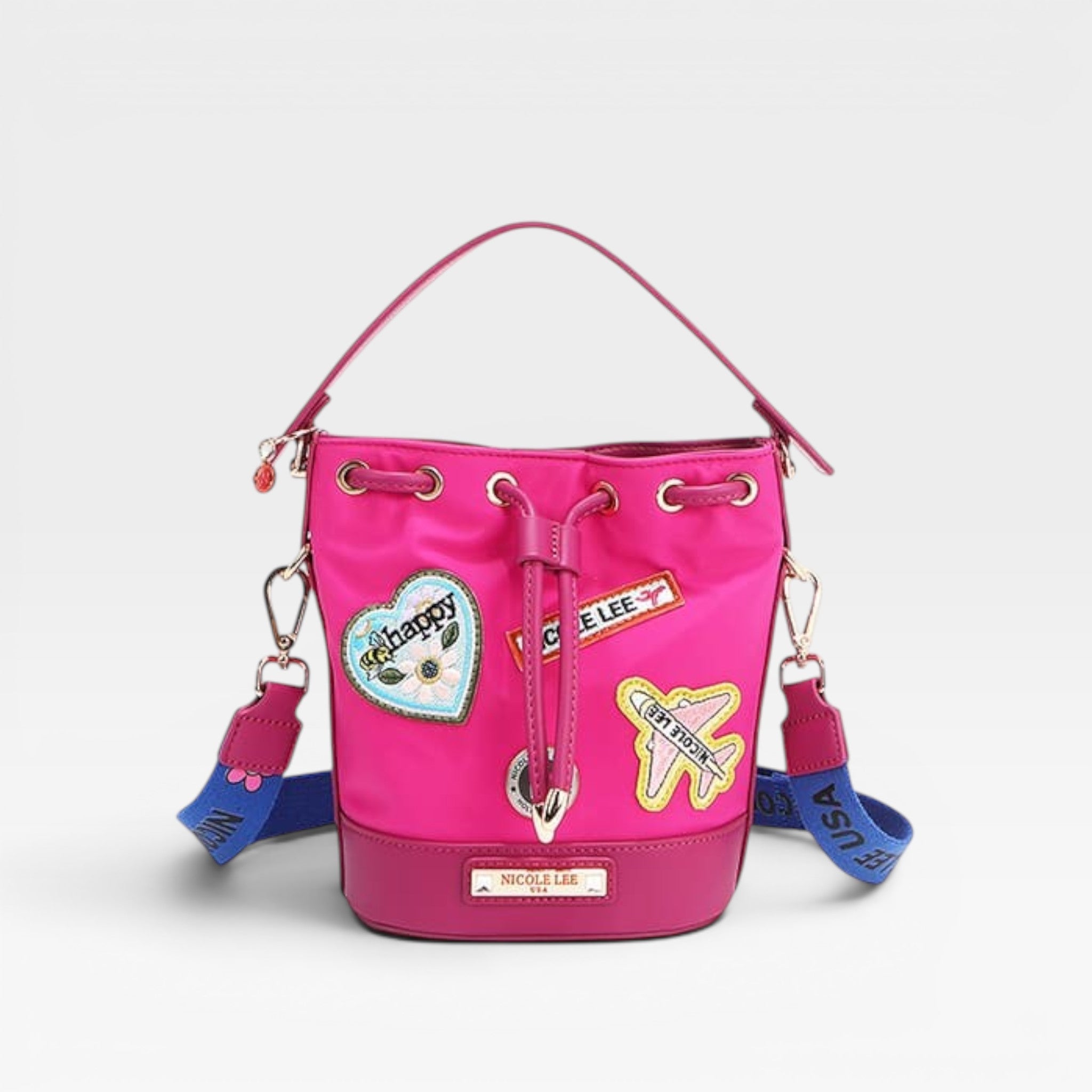 Pink bucket bag with colorful patches and a blue strap on a light gray background