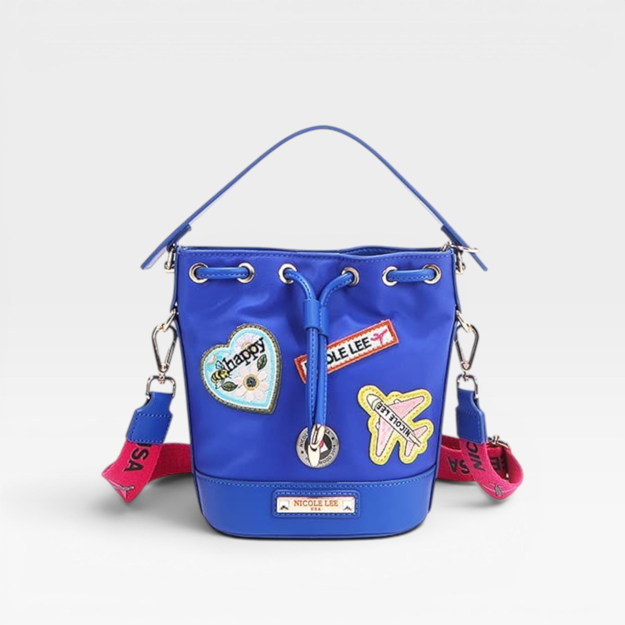 Blue bucket bag with colorful patches on a light gray background