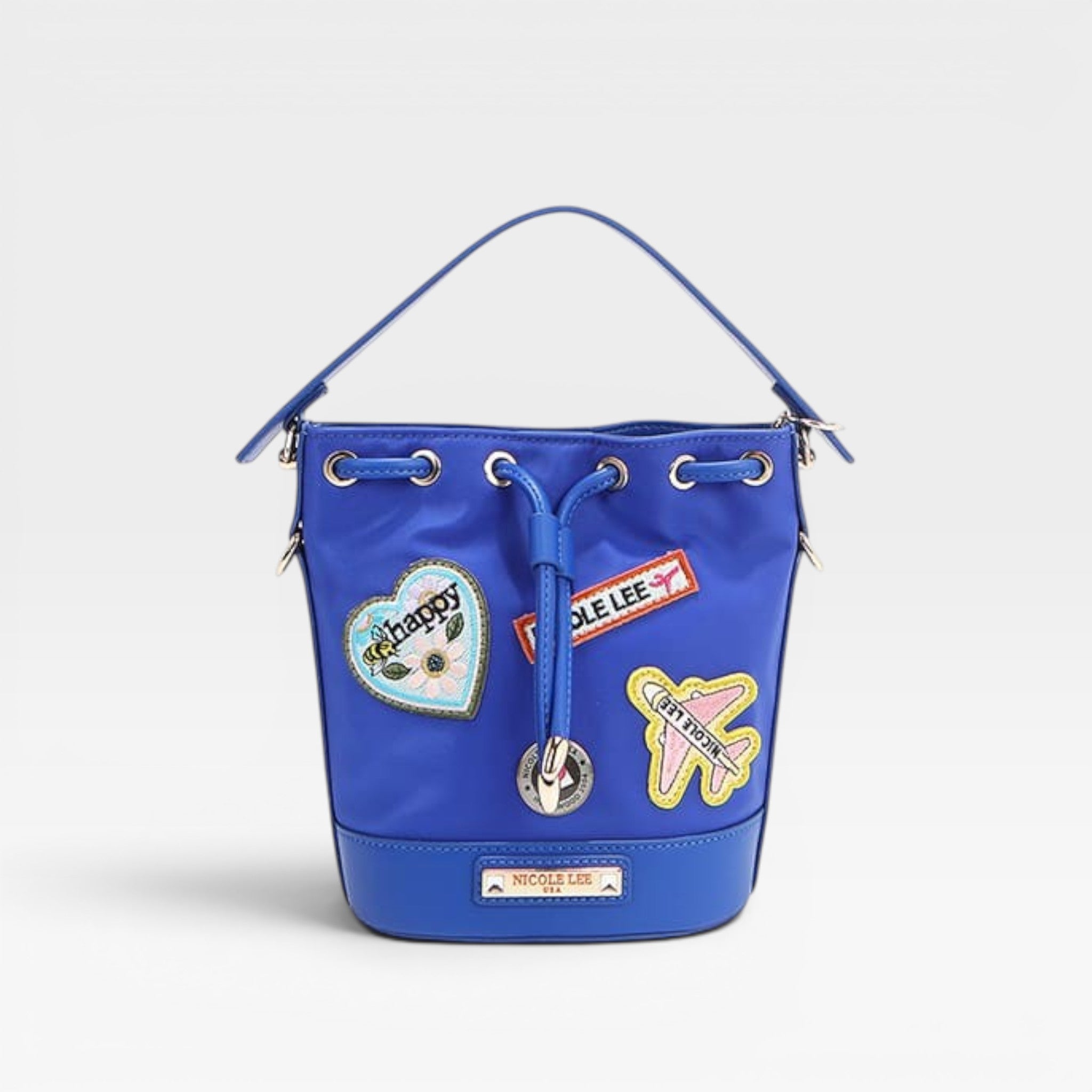 Blue bucket bag with patches on a light gray background