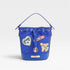 Blue bucket bag with patches on a light gray background