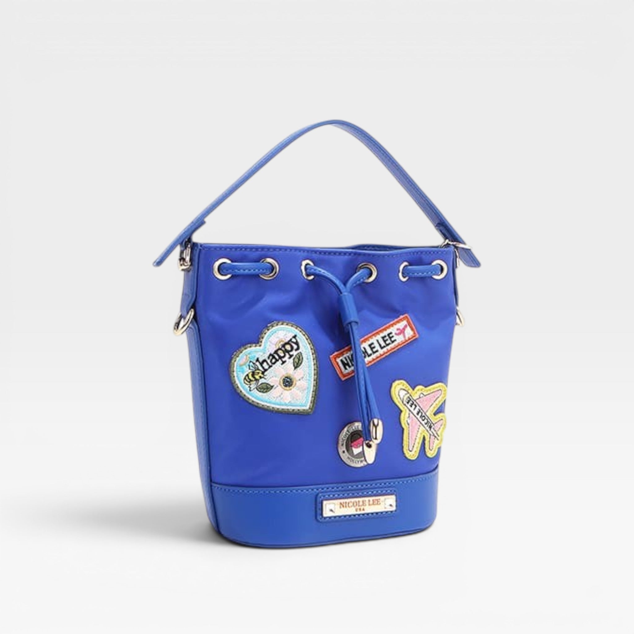 Blue bucket bag with patches on a light gray background