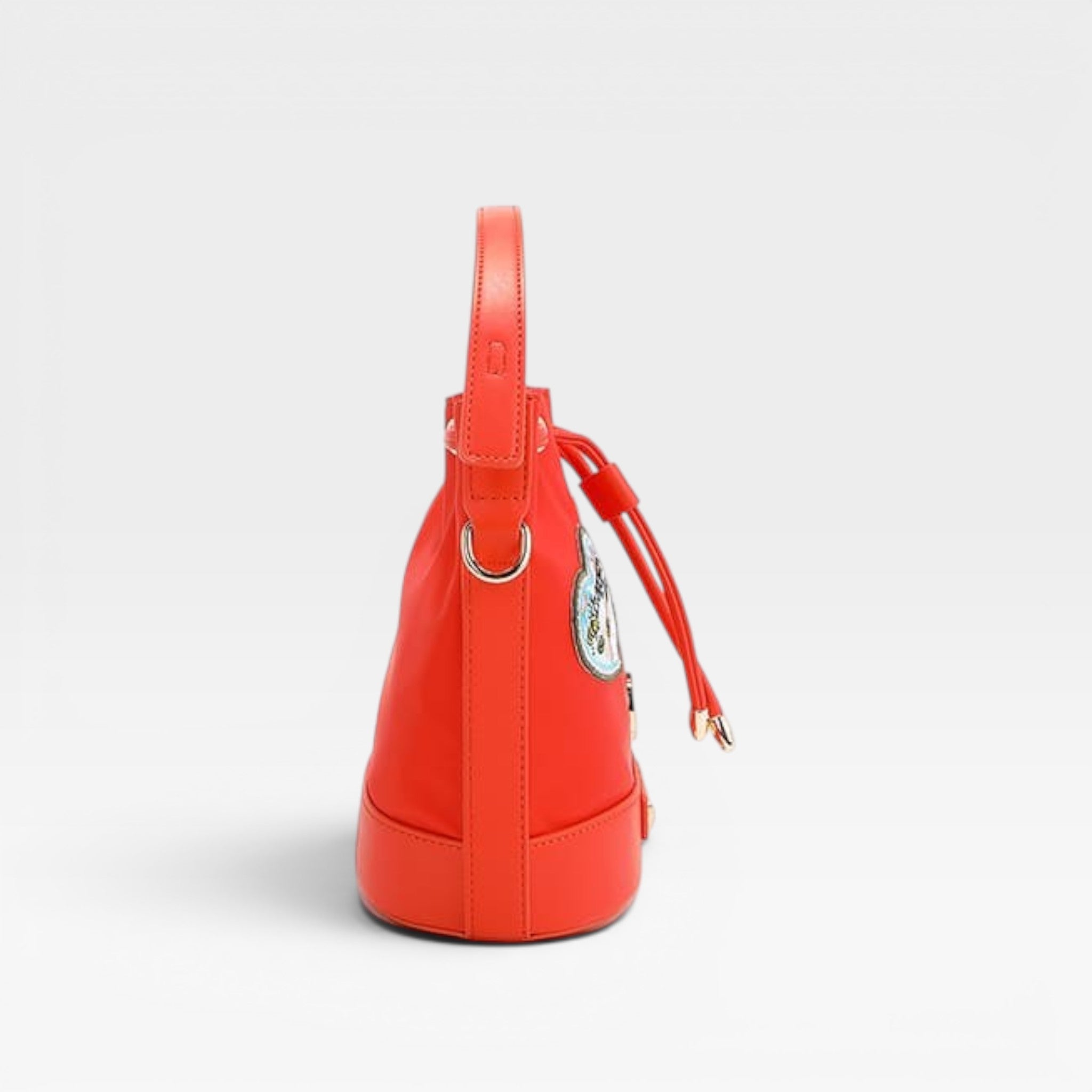 Red handbag with a drawstring on a light gray background