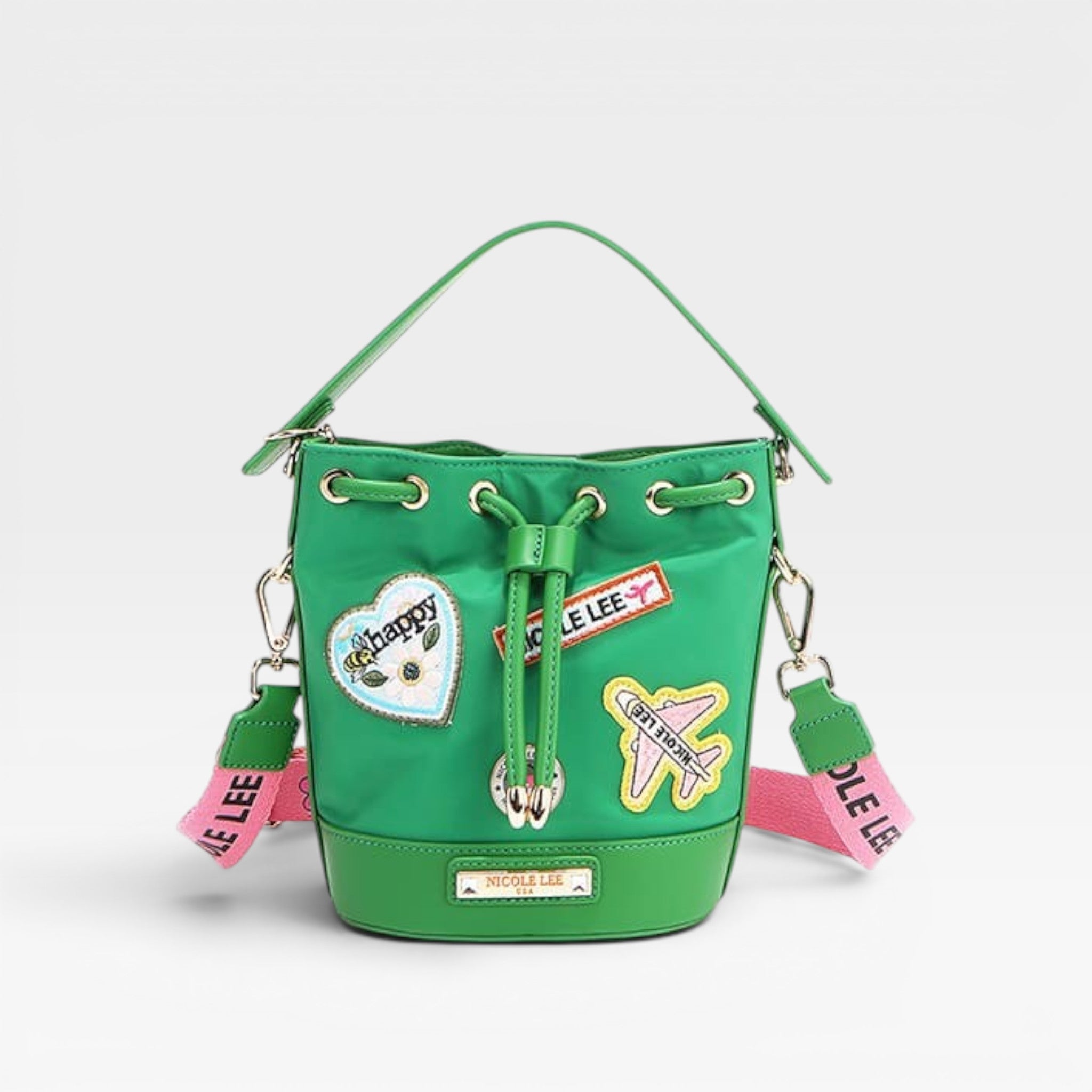 Green bucket bag with patches and tags on a light gray background