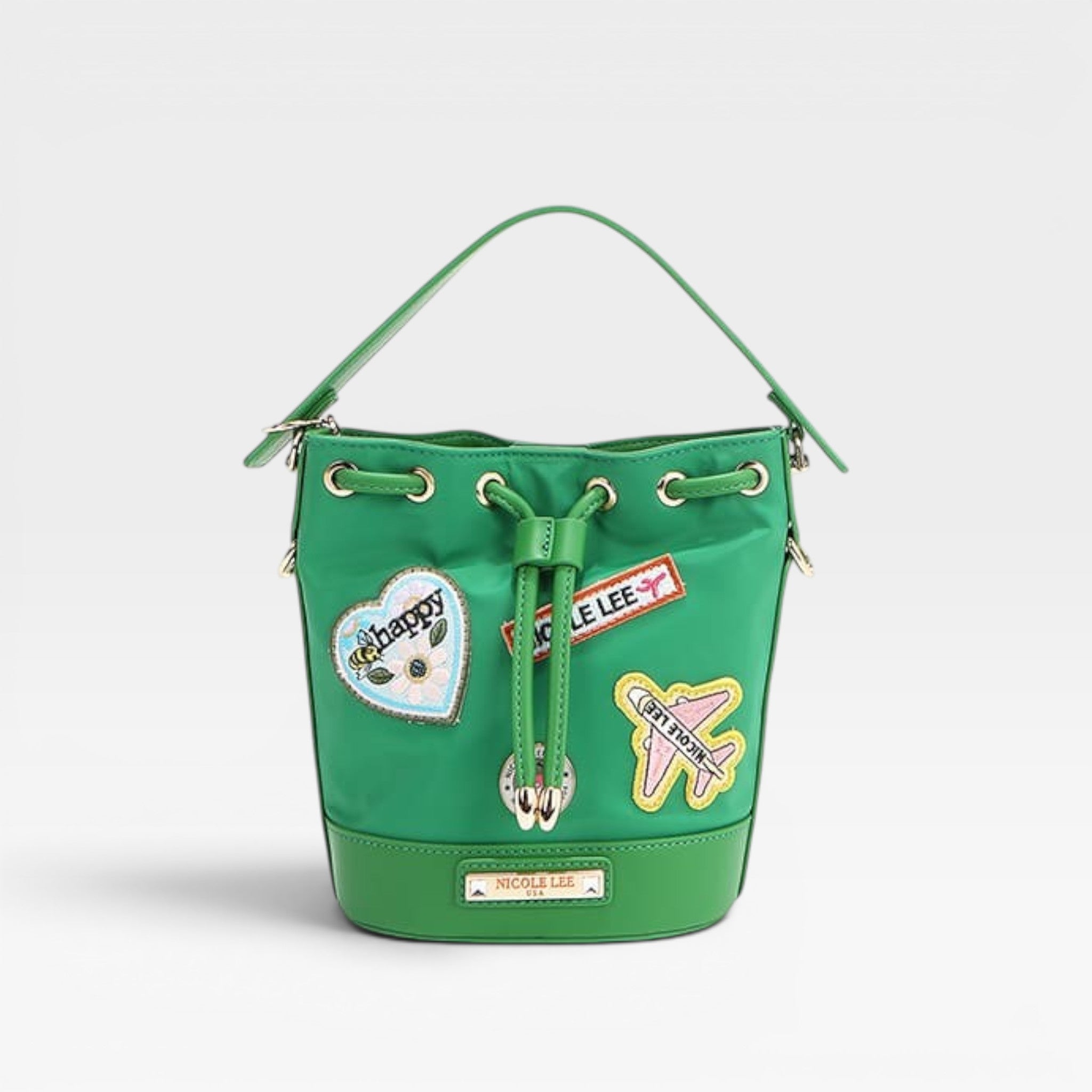 Green handbag with patches on a light gray background