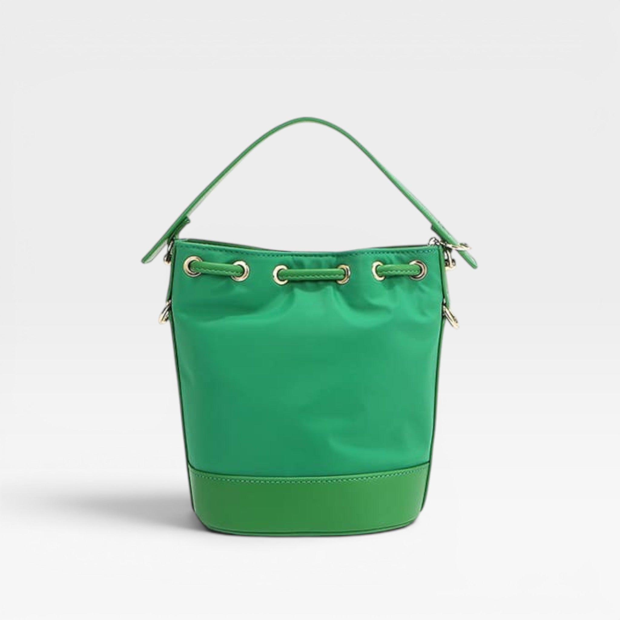 Green bucket bag with gold accents on a light gray background