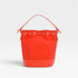 Red bucket bag with a strap on a light gray background