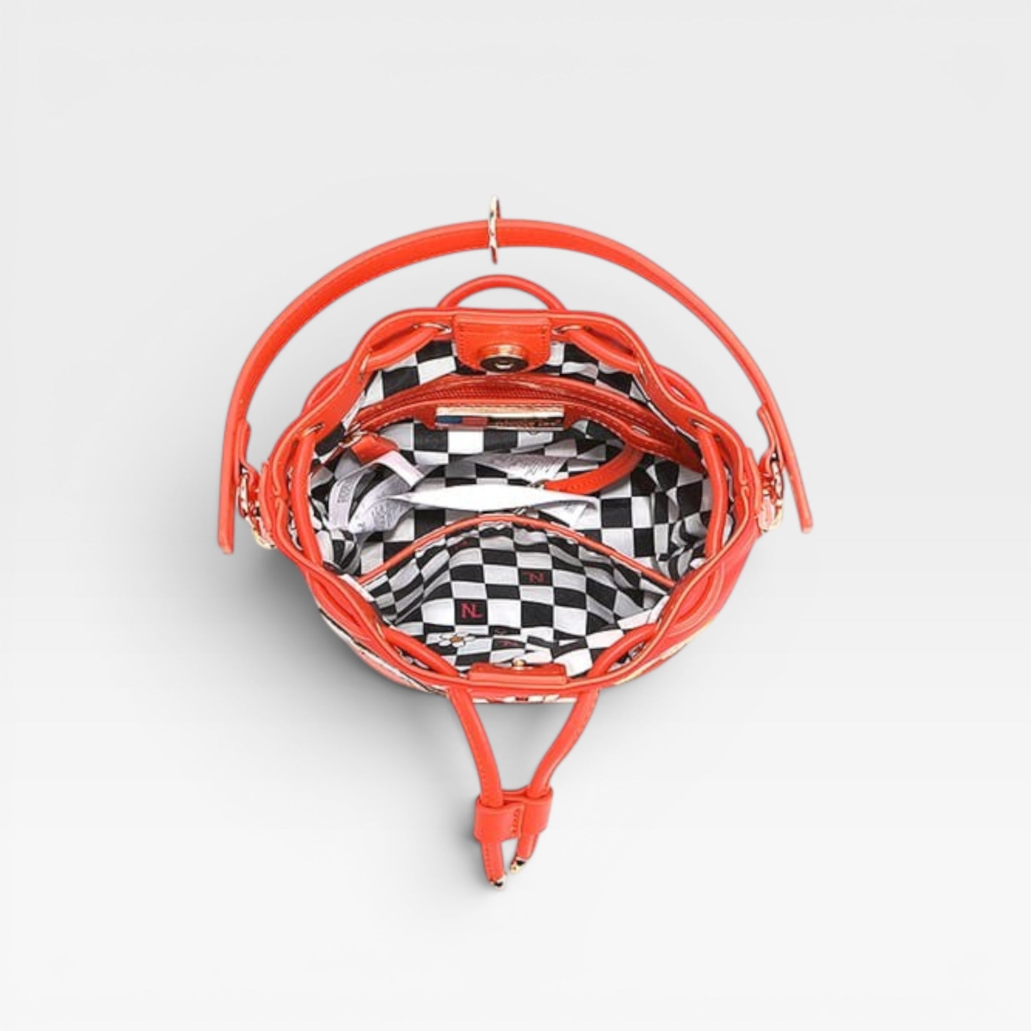 Orange lip-shaped bag with checkered interior on a light gray background