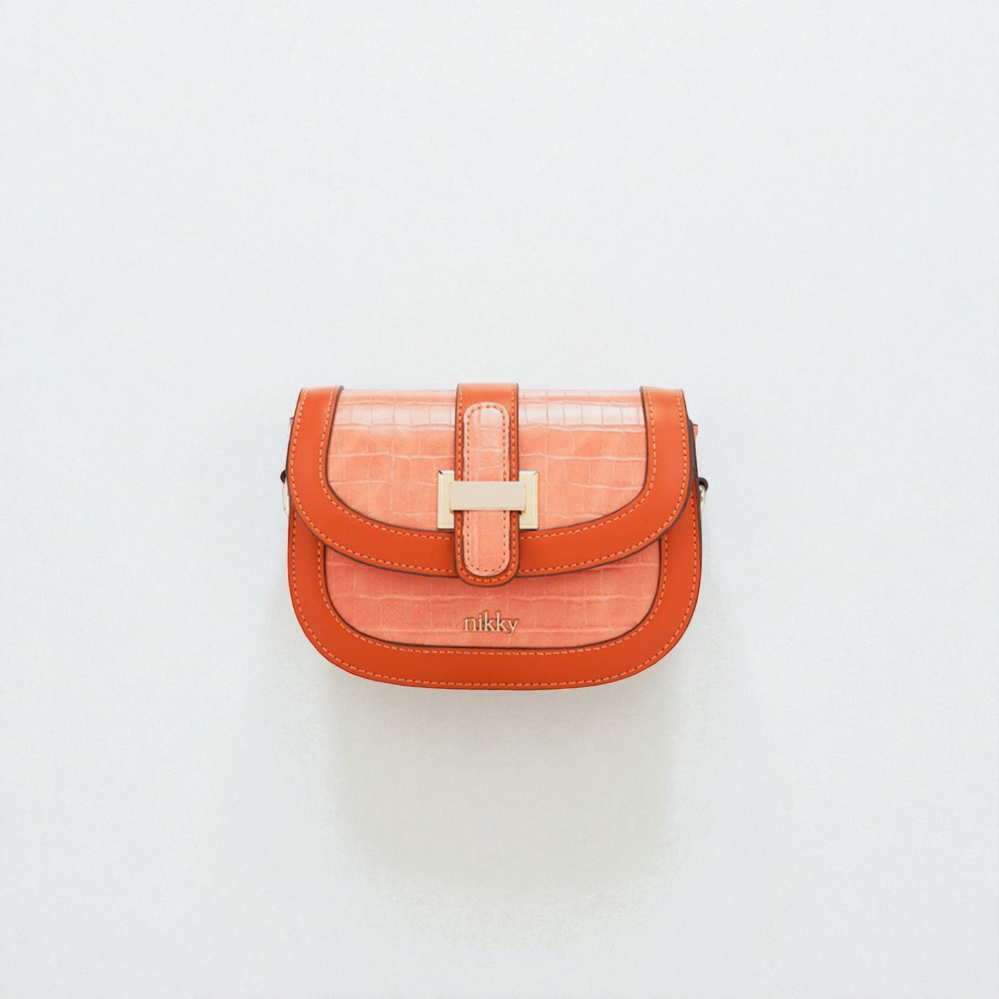Orange handbag with a gold clasp on a light gray background