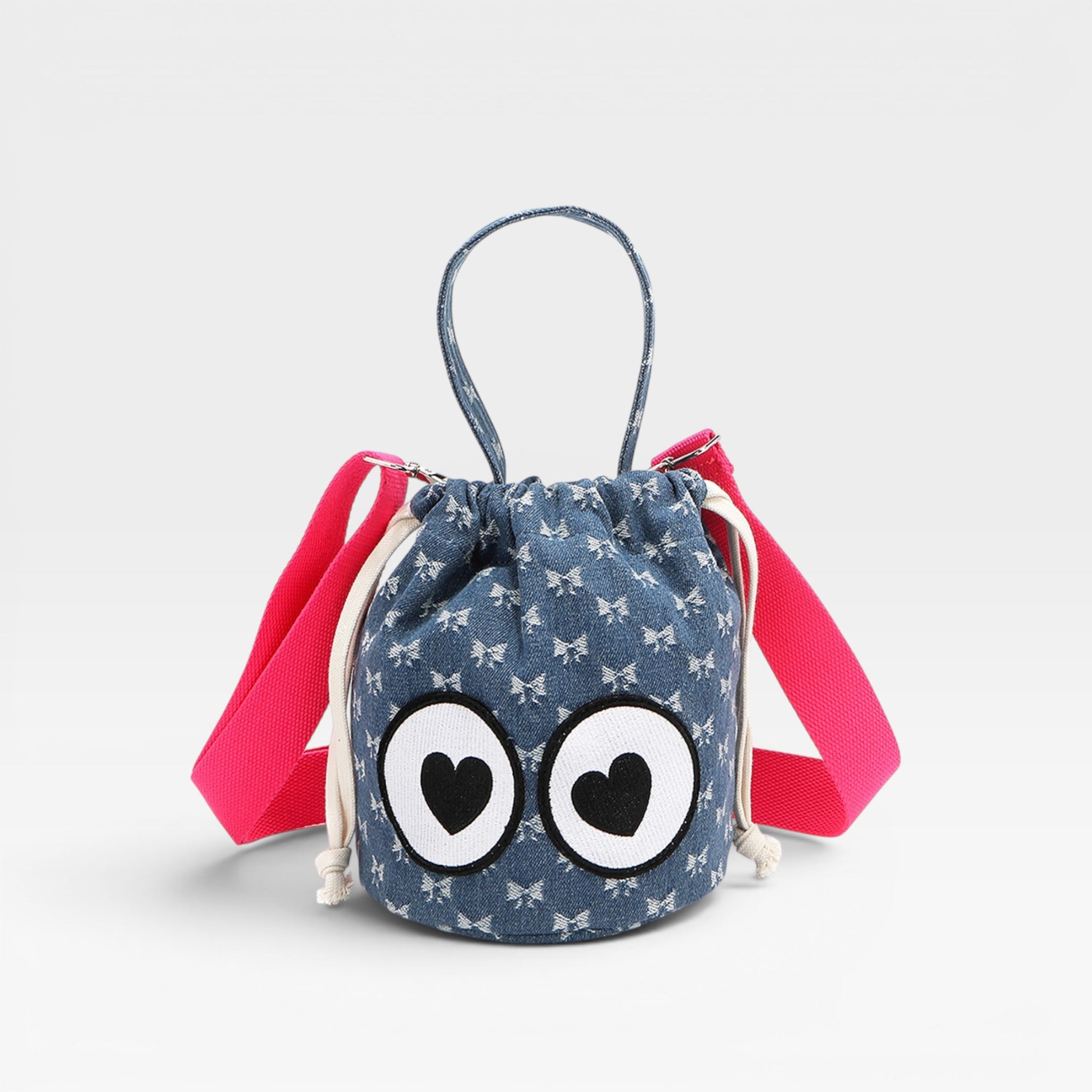 Small blue drawstring bag with cartoon eyes and pink straps on a light gray background