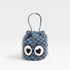 Blue drawstring bag with cartoon face on a light gray background