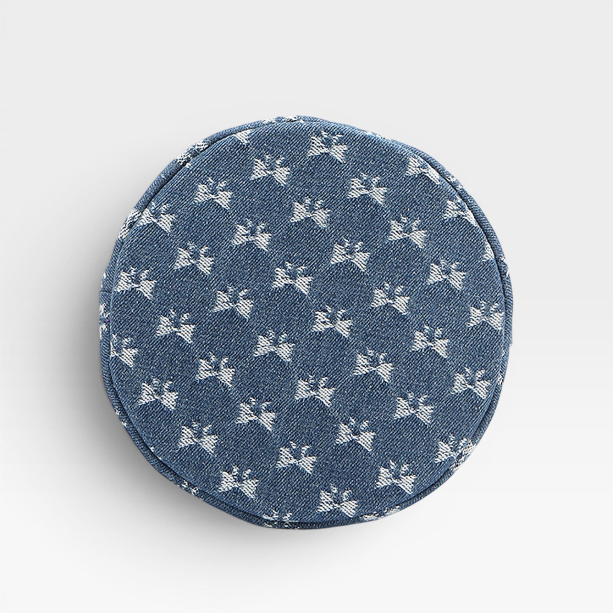 Round denim patch with white bow pattern on a light gray background