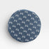 Round denim patch with white bow pattern on a light gray background