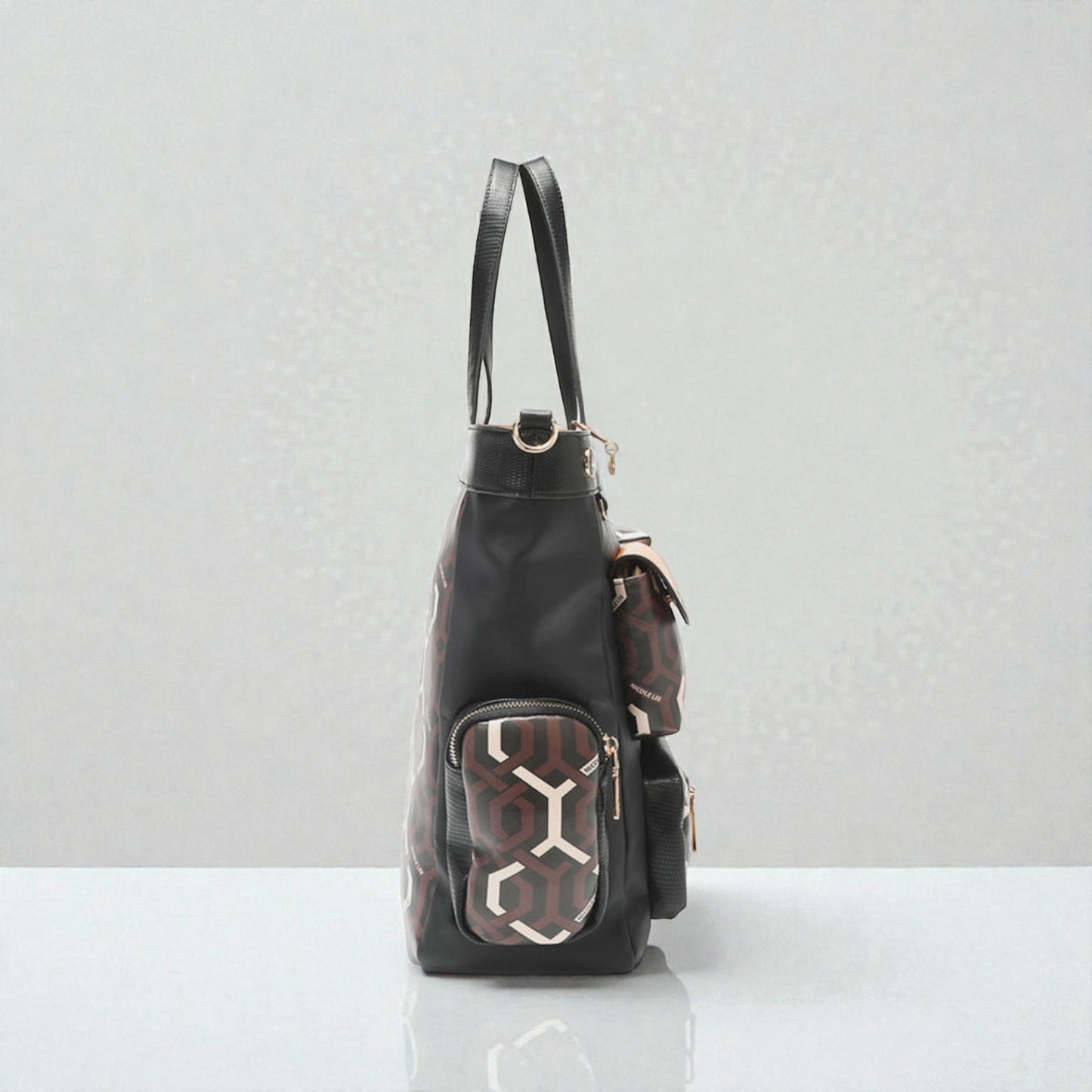 Black backpack with geometric pattern on a white surface and light gray background