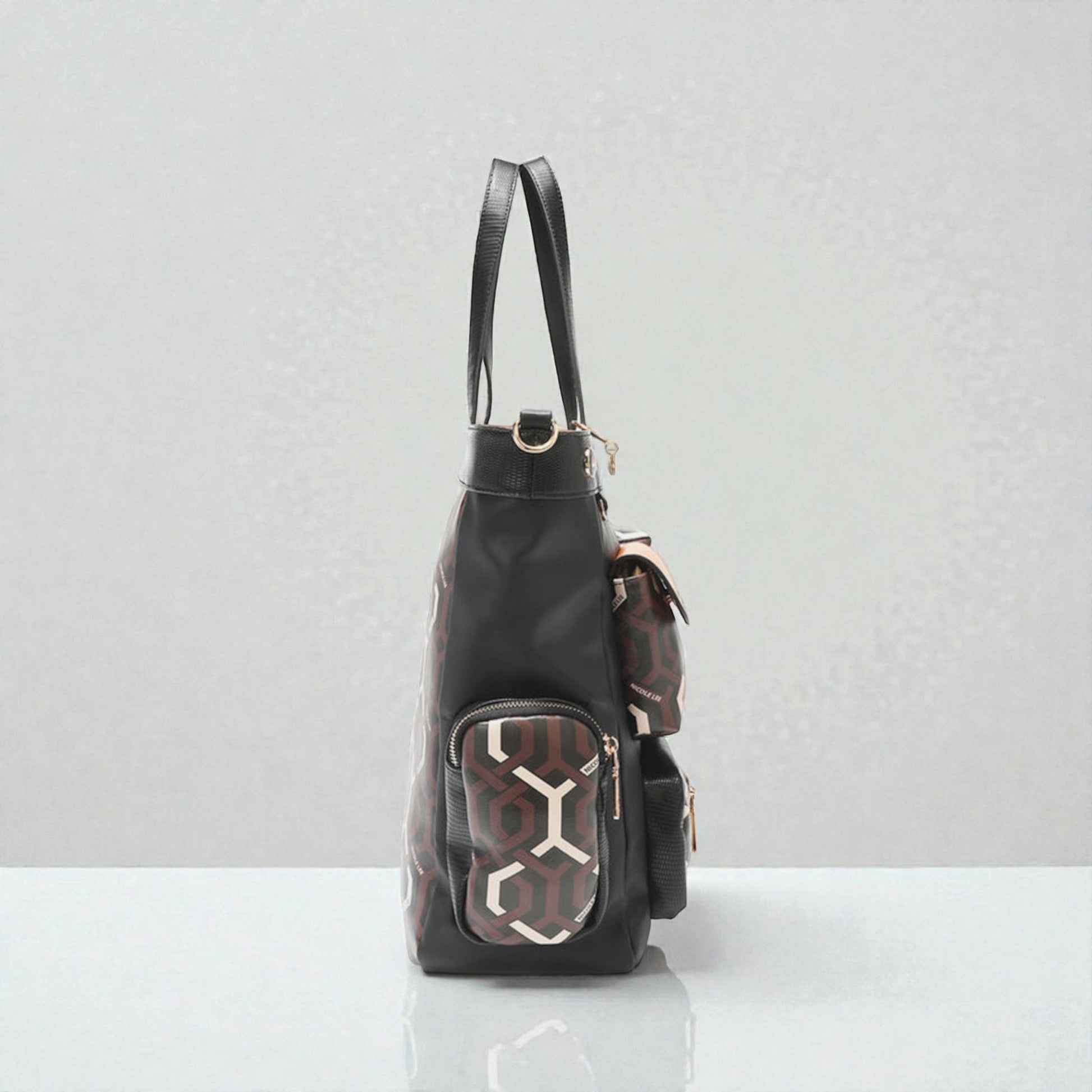 Black backpack with geometric pattern on a white surface and light gray background