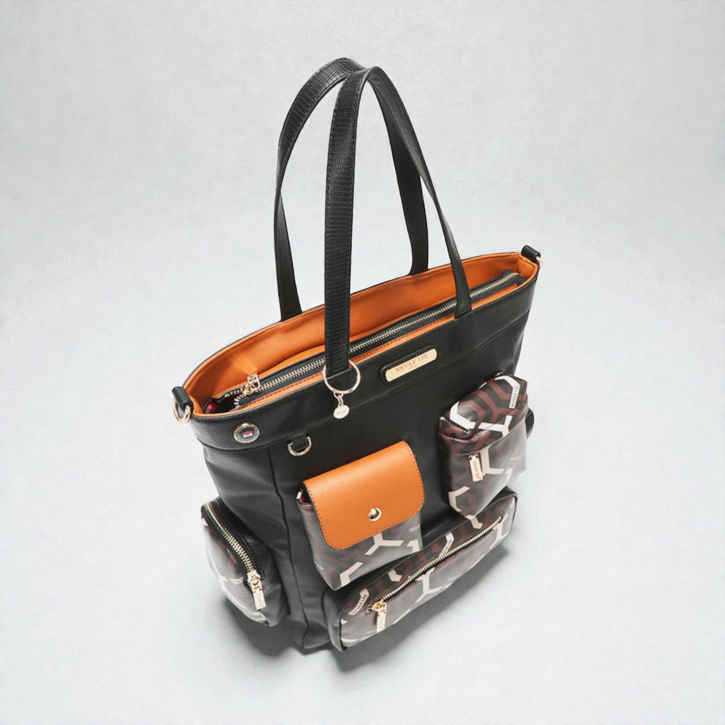 Black handbag with compartments on a light gray background