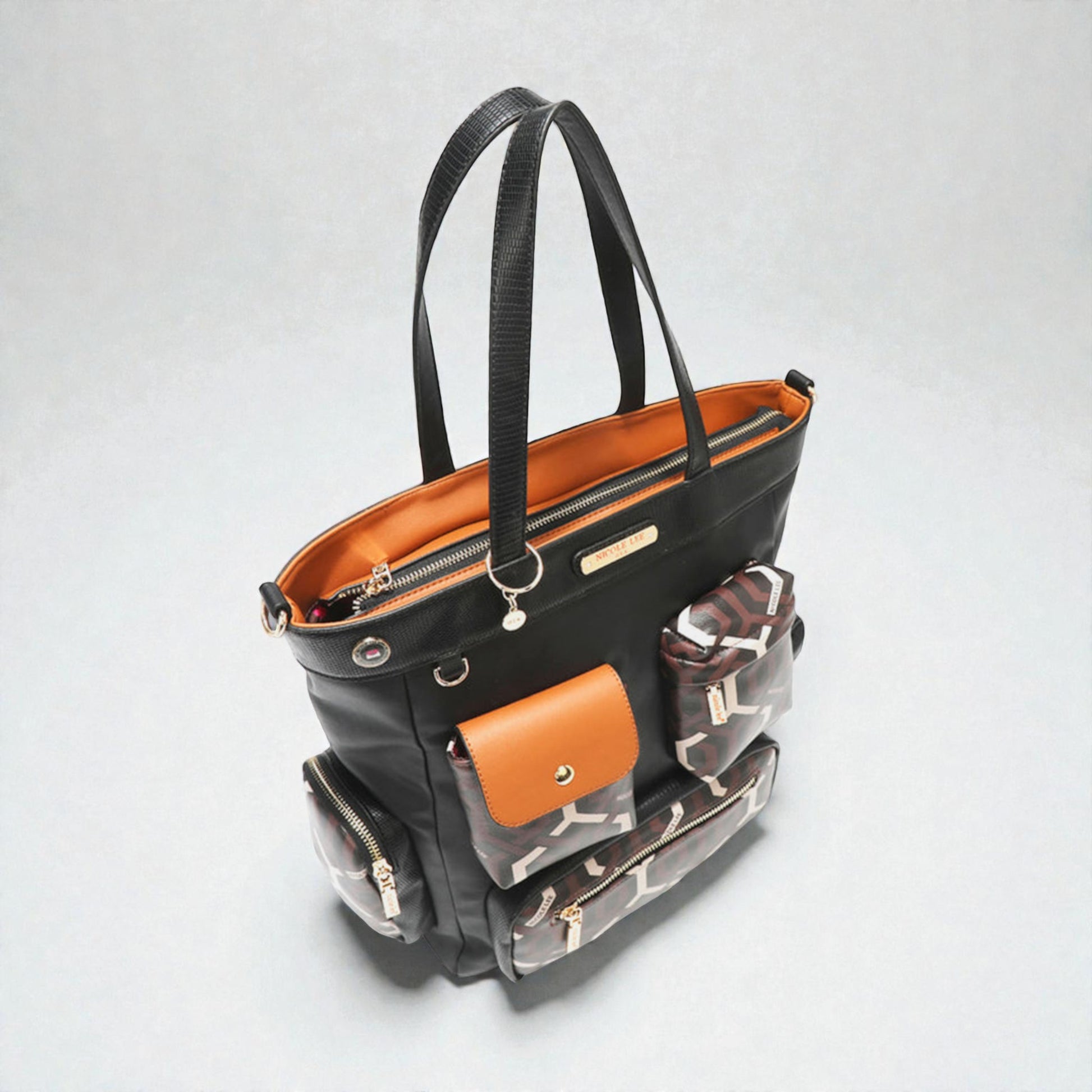 Black handbag with compartments on a light gray background