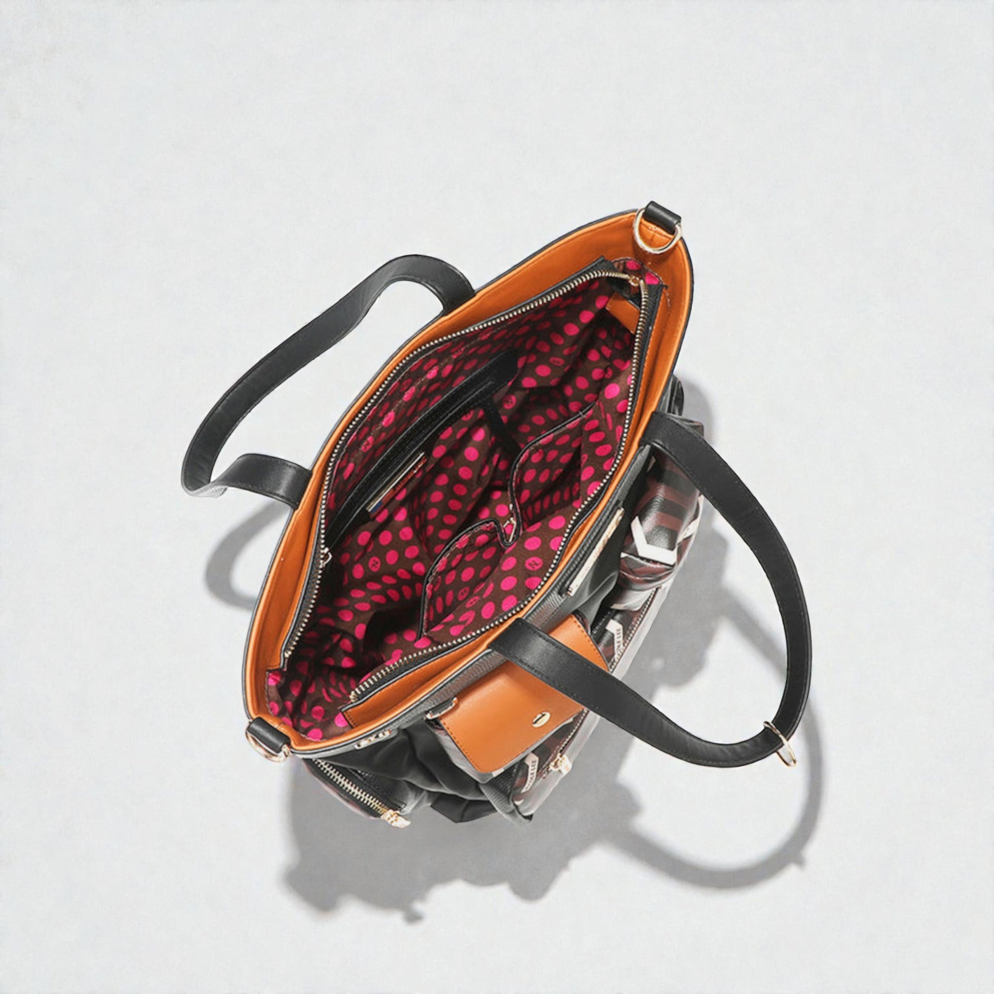 Open handbag with polka dot interior on a light gray background