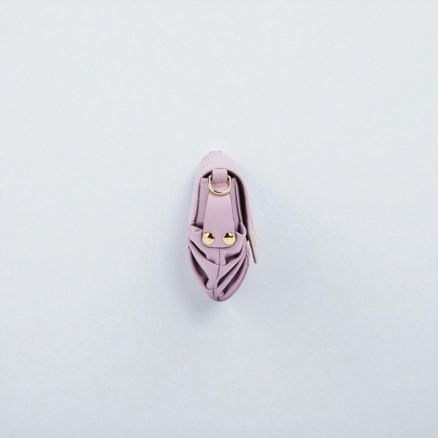 Pink leather keychain with gold accents on a light gray background