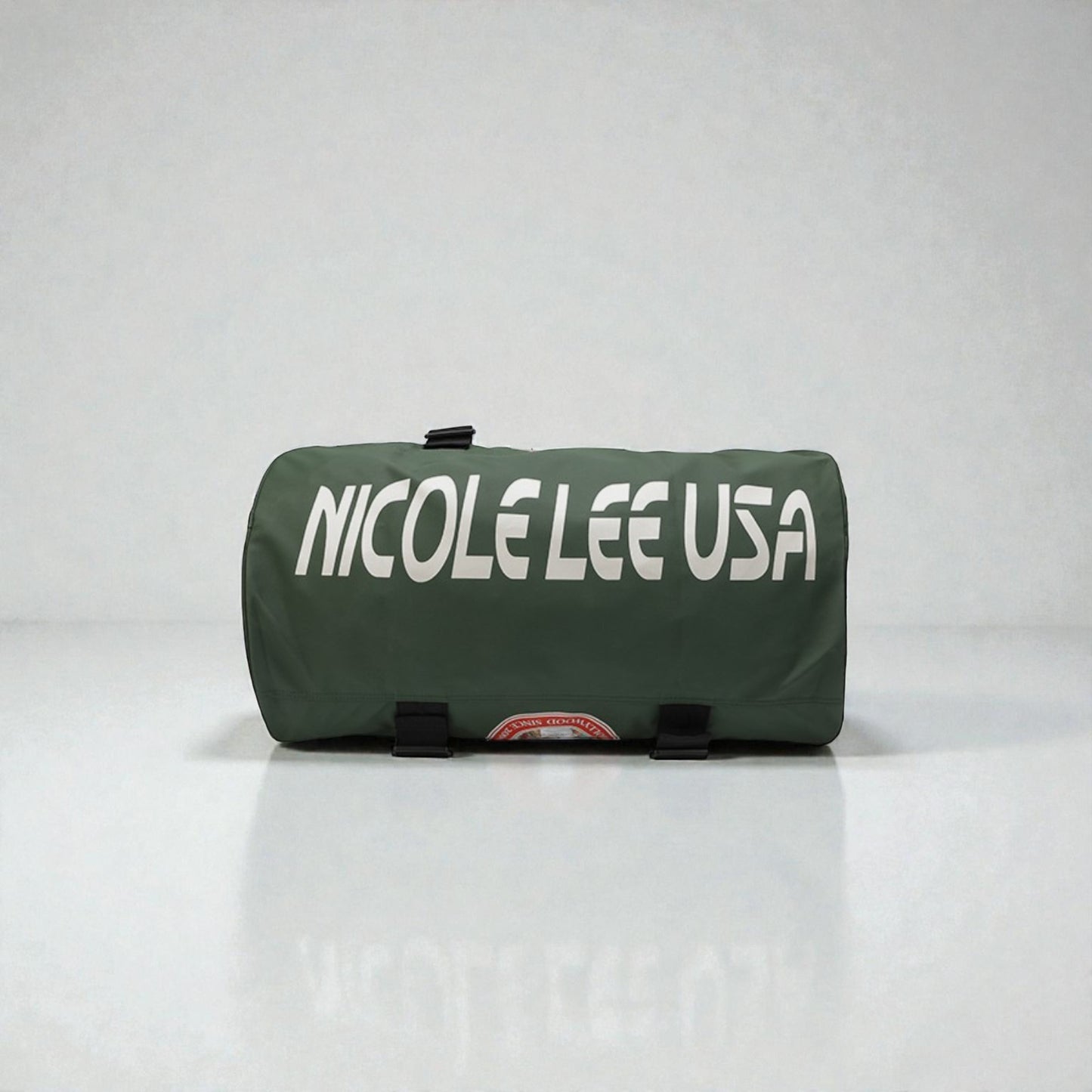 Green duffel bag with 'NICOLE LEE USA' text on a white background