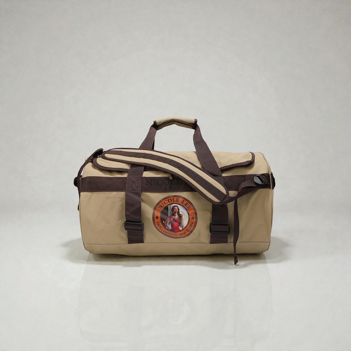 Beige duffel bag with brown straps on a light gray background