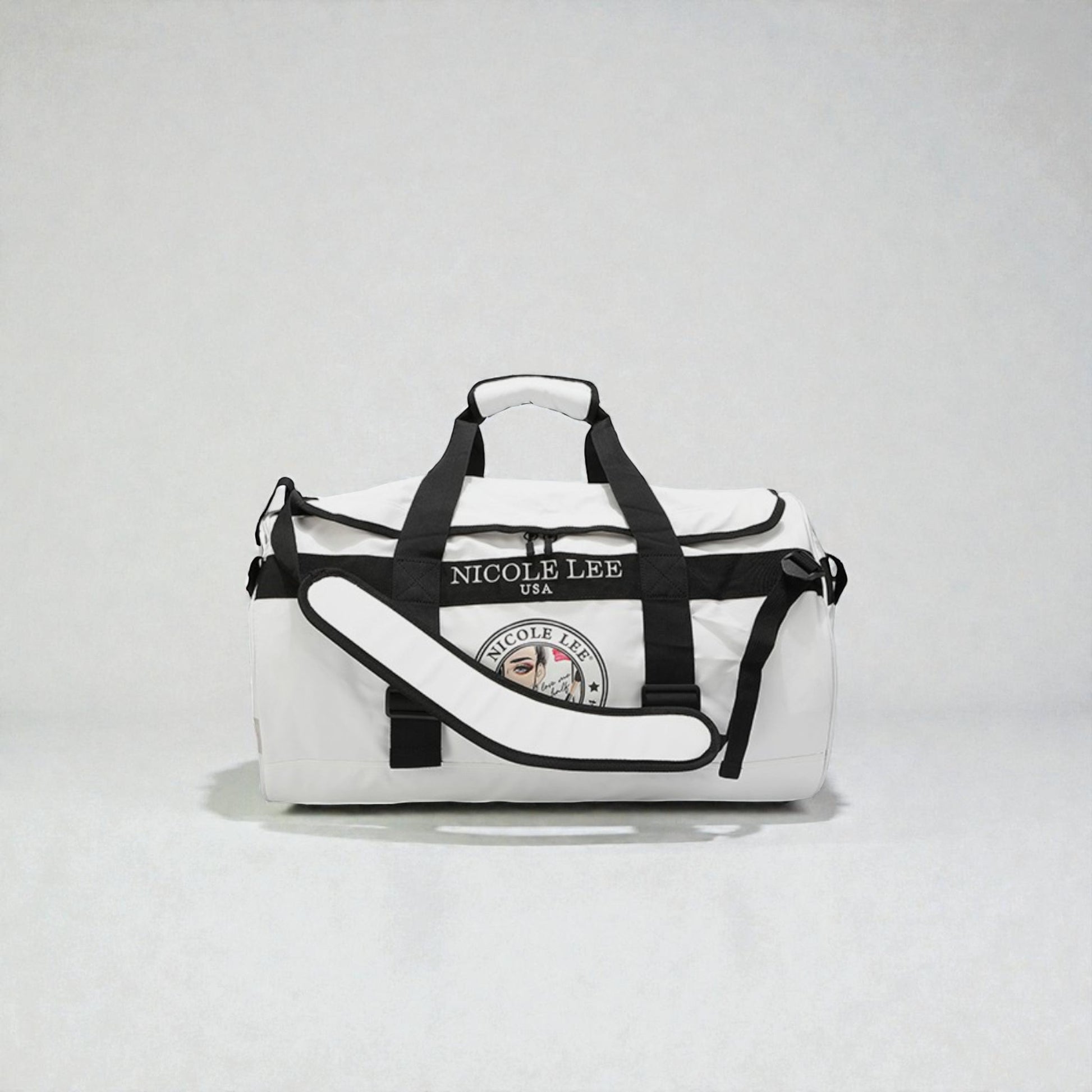 White duffel bag with black straps and 'Nicole Lee' branding on a light gray background