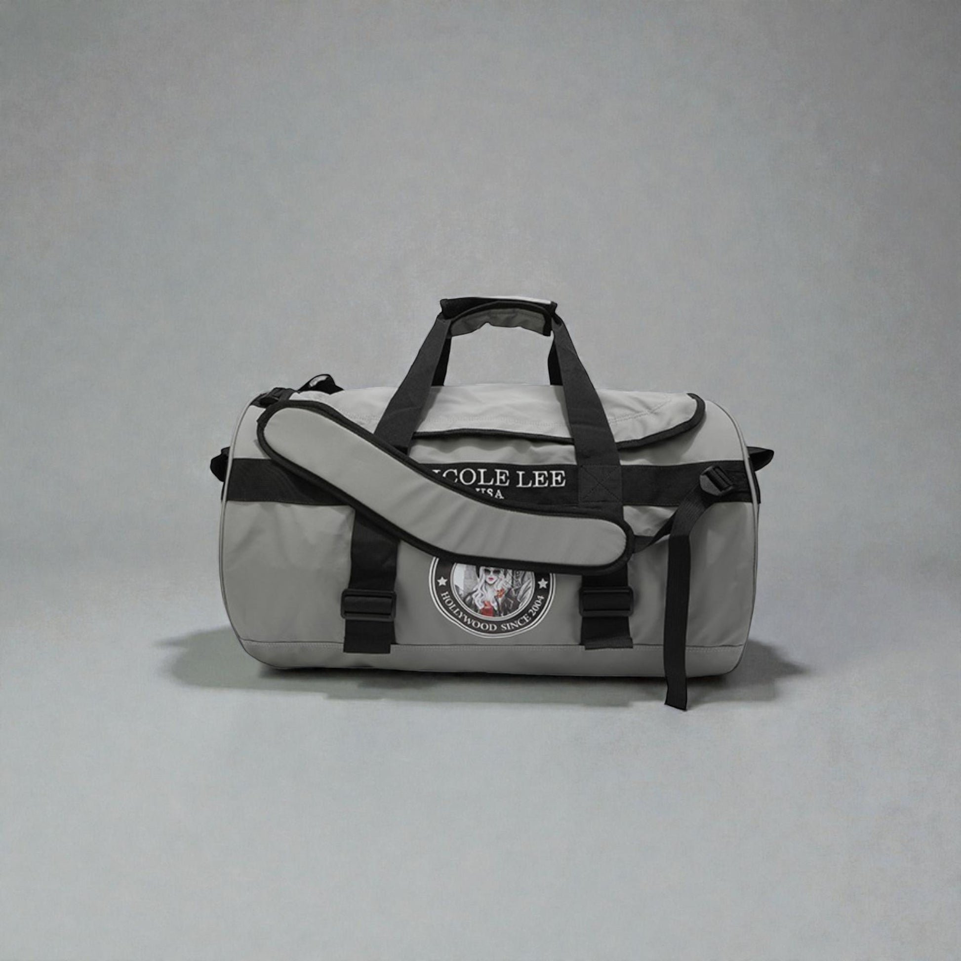 Gray duffel bag with black straps and Cole Lee branding on a gray background
