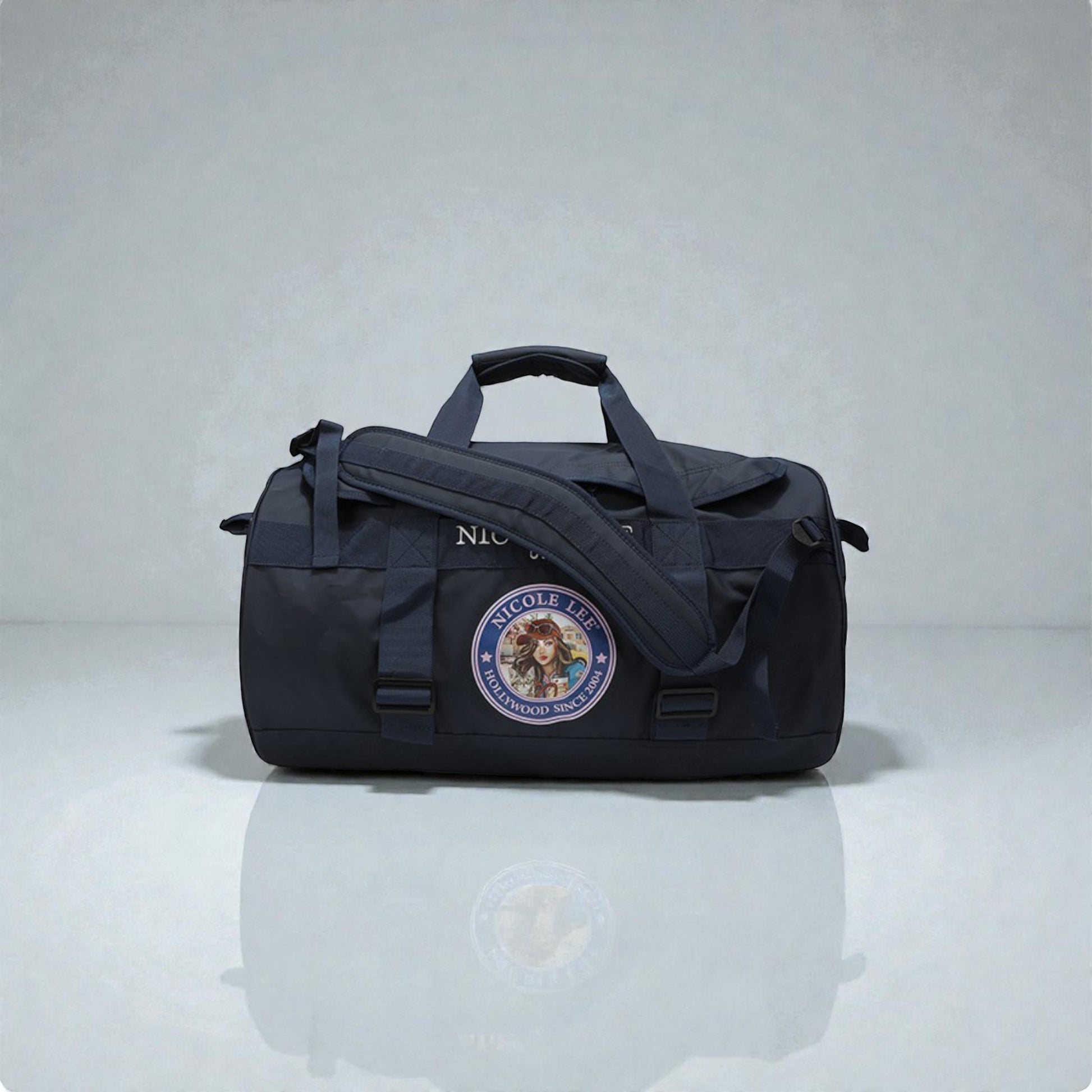 Black duffel bag with a logo on a reflective surface and light gray background